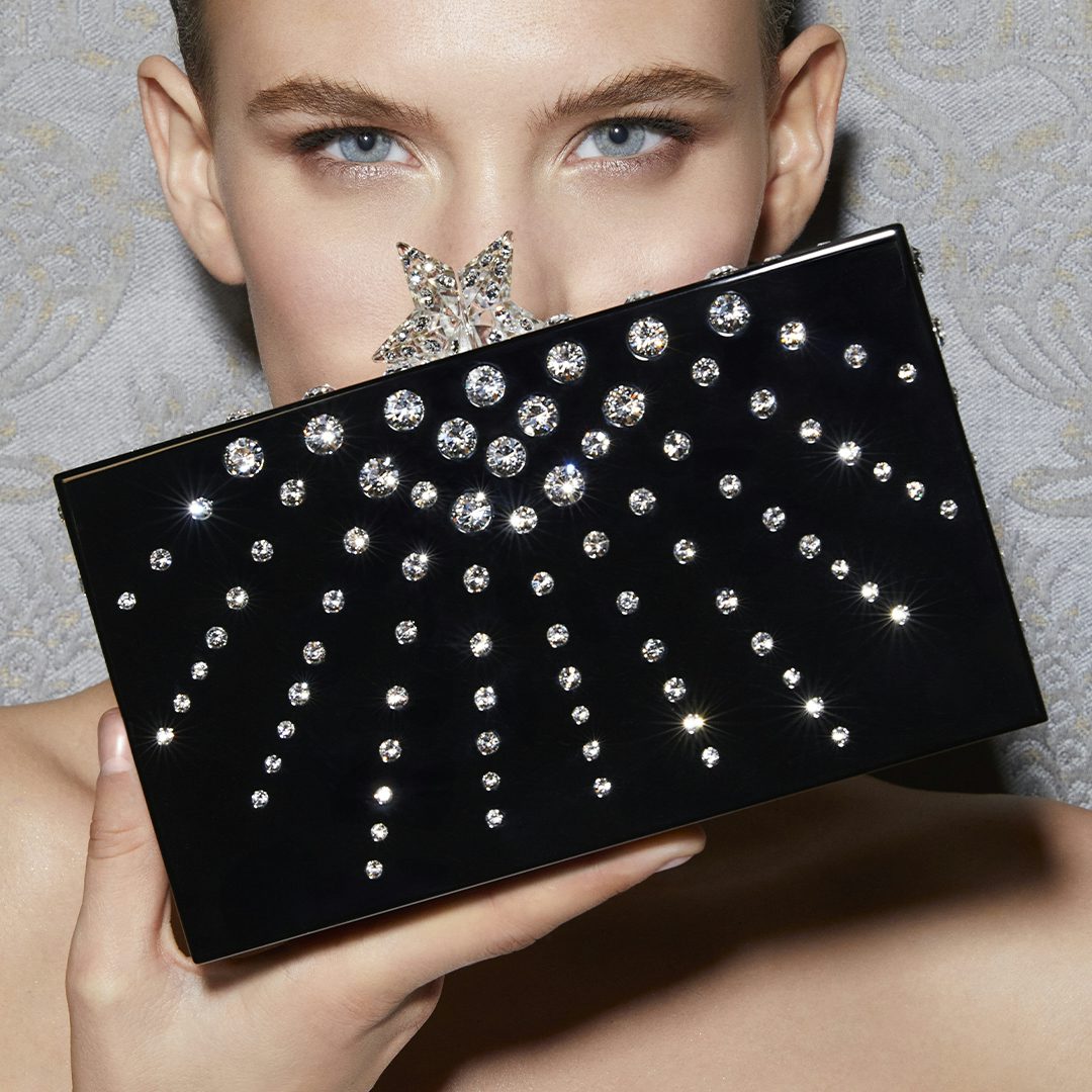 Discover the latest bags, such as the Starlight clutch in black resin encrusted with crystals.