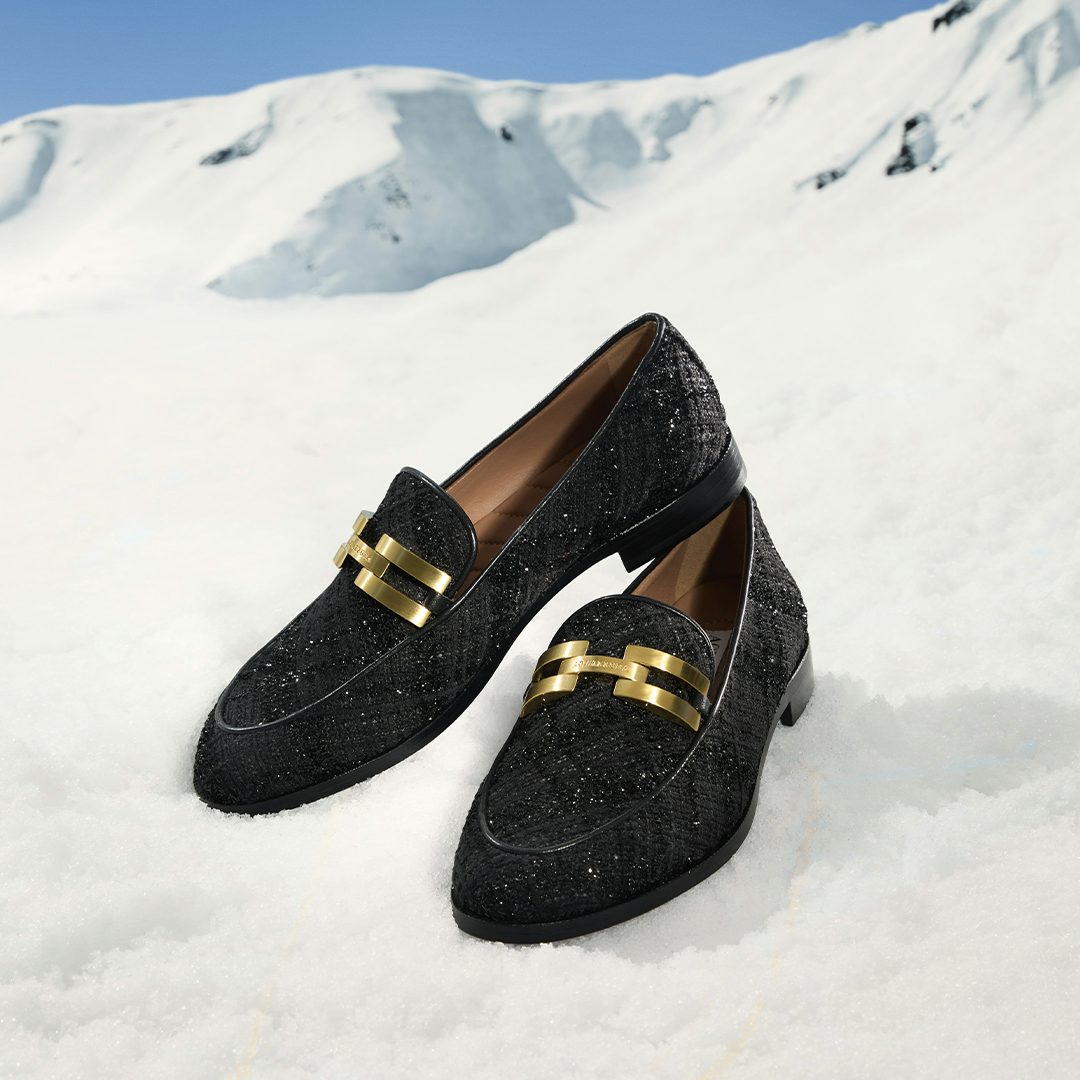 Steal the show in a pair of our black bouclé Brandi Moccassins. The snow of the mountain slope in the background, accentuates glow of these exquisite essentials.