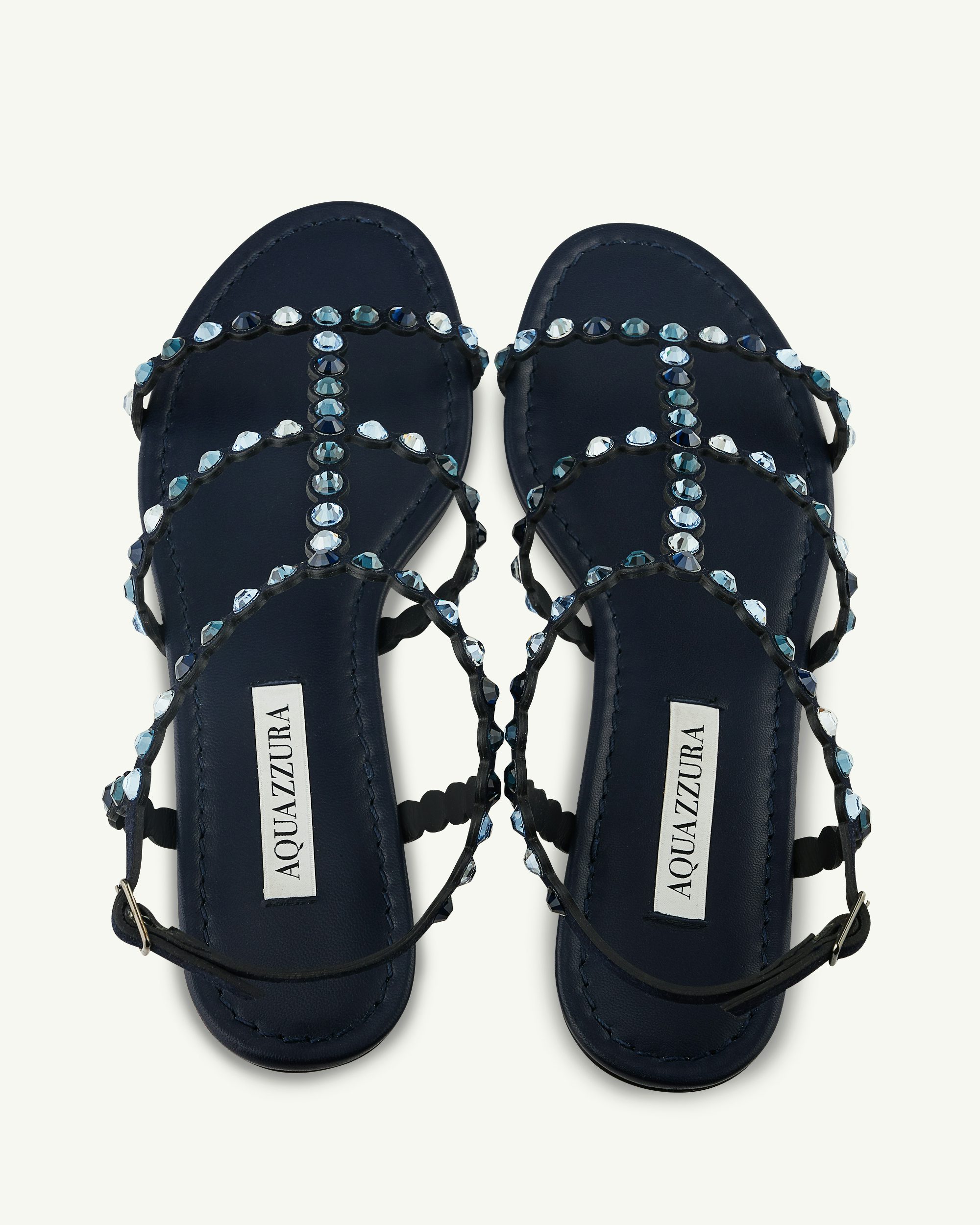 Aquazzura closed store toe flat sandals with Swarovski crystal jewel detail.